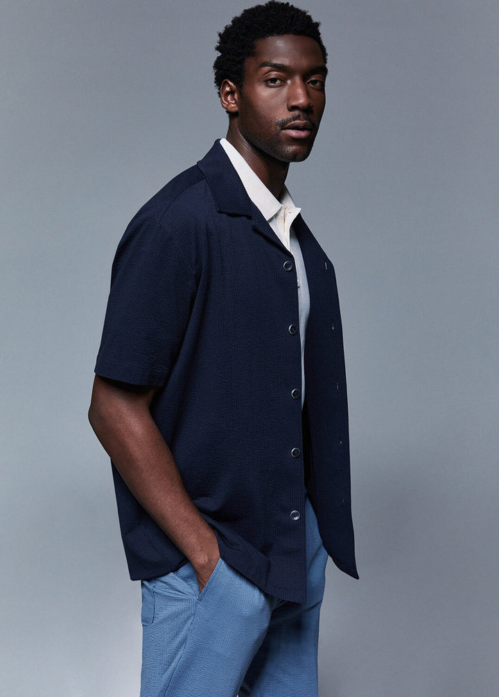 Camicia martellata Bowling Fit LIU-JO in tessuto bianco con dettagli eleganti, maniche lunghe e colletto classico.